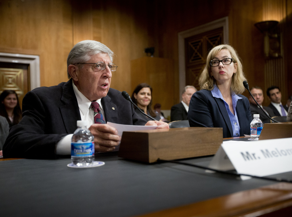 Joe Melomo of Austin, Texas, left, accompanied by Dama Brown, director of the Federal Trade Commission for the Southwest region, testifies on Capitol Hill in Washington on Wednesday before the Senate Special Committee on Aging hearing on “Exploring the Perils of the Precious Metals Market.” Melomo said he lost more than $200,000 after investing in gold and silver.