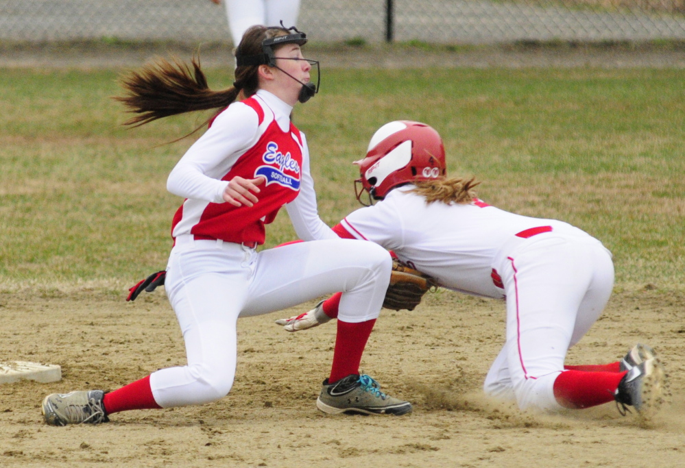 Staff photo by Joe Phelan Messalonskee shortstop Maddi Charest tags out Cony baserunner Michaela Dostie in front of second base during a game on Wednesday April 30, 2014 at Cony Family Field in Augusta.