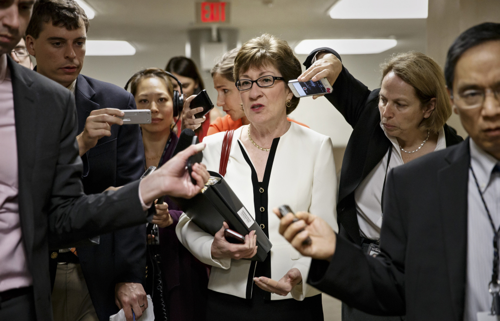 Sen. Susan Collins, R-Maine, is surrounded by reporters as she rushes to the Senate chamber on Capitol Hill in Washington on Wednesday for a key vote on the Minimum Wage Fairness Act, which she opposed. Collins has been seeking a deal with other senators on a lower figure than Democratic target amount of $10.10 for the federal minimum wage.
