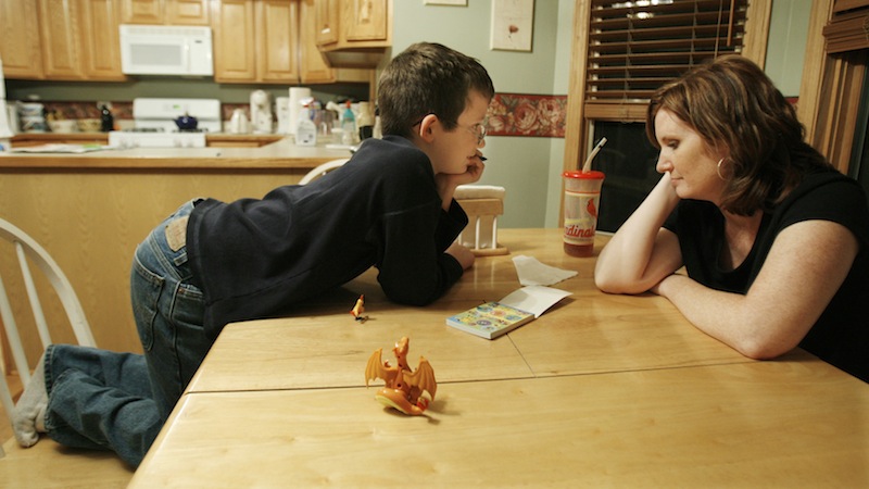 In this 2006 file photo, Nicholas Chamernik, 9, shows his mom, Aimee, some of his Pokemon stickers. More women are staying at home full-time to raise their children, according to a new Pew Research Center report released Tuesday.