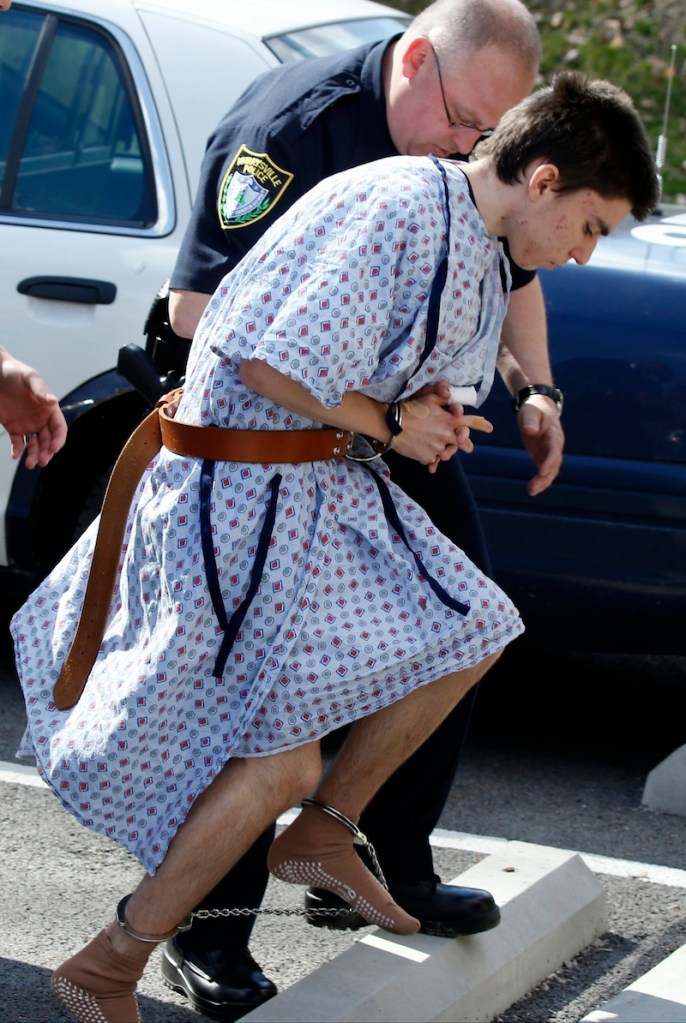 Alex Hribal, the suspect in the multiple stabbings at the Franklin Regional High School in Murrysville, Pa., is escorted by police to a district magistrate to be arraigned on Wednesday, April 9, 2014, in Export, Pa. Authorities say Hribal has been charged after allegedly stabbing and slashing at least 19 people, mostly students, in the crowded halls of his suburban Pittsburgh high school Wednesday.