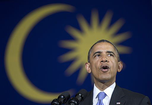 With a Malaysian flag behind him, President Obama speaks during a town hall meeting at Malaya University in Kuala Lumpur, Malaysia, on Sunday.