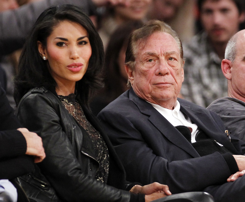 Los Angeles Clippers owner Donald Sterling sits with V. Stiviano at a Clippers game. Sterling was talking to Stiviano when he was recorded making racist remarks.