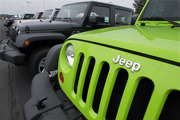 In this July 1, 2012 file photo, Jeeps sit for sale at a Chrysler dealership in Springfield, Ill. Fiat and Chrysler announced an agreement Saturday, April 19, 2014, that they will build three new Jeep models in China for the local market, the biggest for Jeeps outside the U.S.