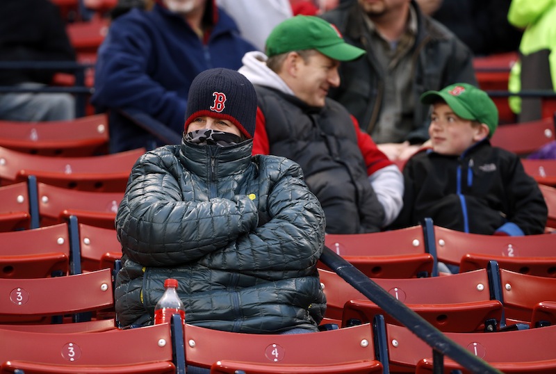 A fan is bundled up against the cold at Fenway Park on Tuesday. Wednesday night's game against the Tampa Bay Rays was rescheduled for Thursday afternoon due to inclement weather.