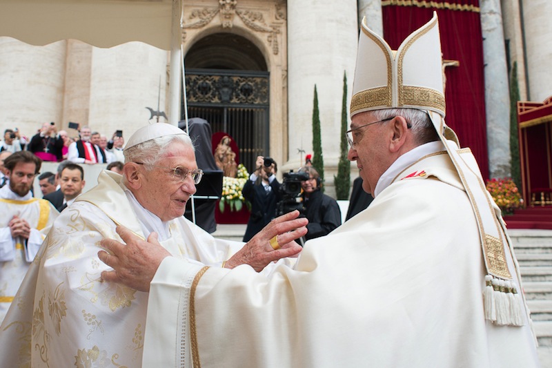 In this photo provided by the Vatican newspaper L'Osservatore Romano, Pope Francis, right, embraces his predecessor Pope Emeritus Benedict XVI, during a ceremony in St. Peter's Square at the Vatican on Sunday.