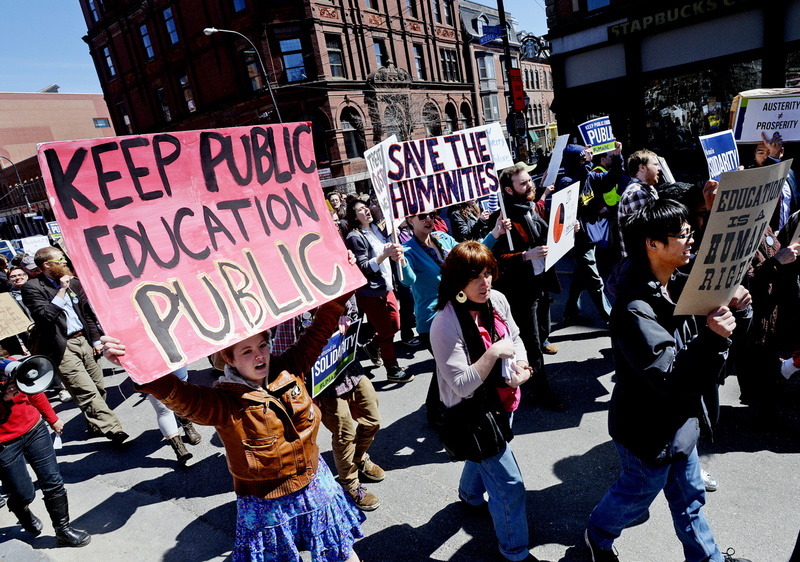 Protesters march down Middle Street in Portland on April 10 as they protest budget cuts at the University of Southern Maine. USM students upset about the pending cuts made their case before the University of Maine System trustees Sunday.