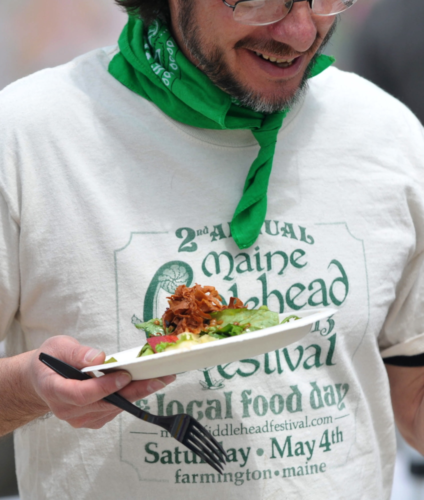 Salad day: Drew Barton tries to find a seat after serving himself a portion of fiddlehead salad during the third annual Fiddlehead Festival in Farmington on Saturday.