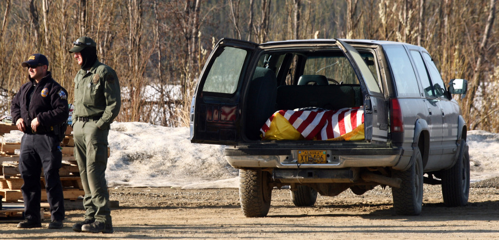 The bodies of Alaska State Trooper Sergeant Patrick “Scott” Johnson and Trooper Gabriel “Gabe” Rich await transport to Anchorage, Alaska on Friday, at the airport in the village of Tanana, Alaska.