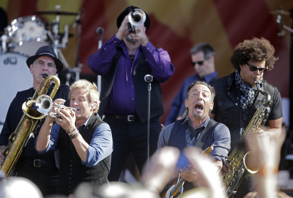 Bruce Springsteen, front right, performs with the E Street Band at the New Orleans Jazz and Heritage Festival in New Orleans, Saturday.