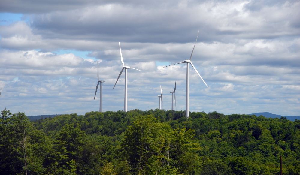 First Wind turbines spin on Stetson Mountain in Maine. The state public advocate’s office has withdrawn its opposition to a multimillion-dollar joint venture by First Wind and Emera to build wind turbines across Maine and the Northeast.
