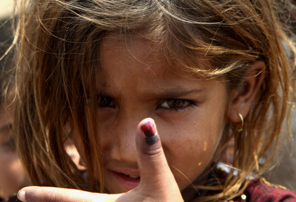 Pakistani girl Amina shows her thumb being marked after receiving polio vaccine in Lahore, Pakistan, Monday, May 5, 2014. For the first time ever, the World Health Organization on Monday declared the spread of polio an international public health emergency that could grow in the next few months and unravel the nearly three-decade effort to eradicate the crippling disease.