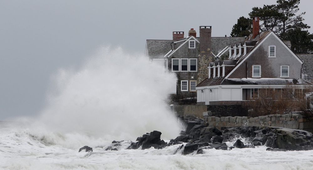 Waves crash into a house in Kennebunk in March 2013, a day when strong surf caused coastal flooding in some York County towns.