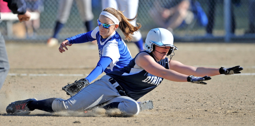 Staff photo by Michael G. Seamans Madison High School's Kayla Bess, 2, tags out Dirigo High School's Kenzie Lord, 9, in Madison on Wednesday. Madison defeated Dirigo 12-0 in six innings.