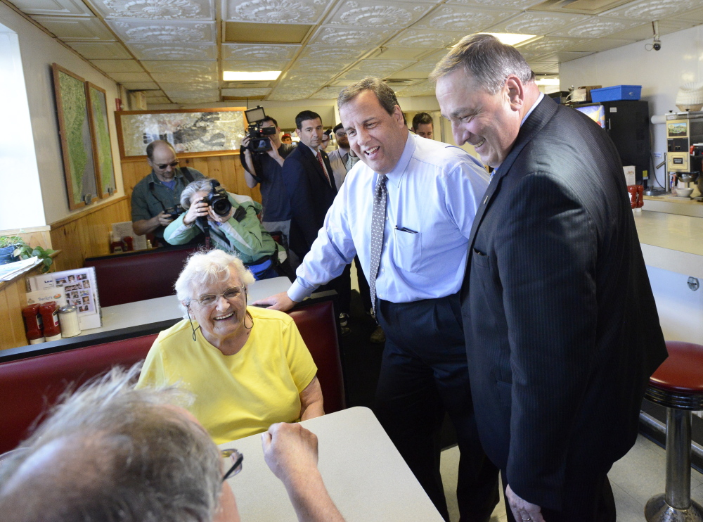 New Jersey Gov. Chris Christie and Maine Gov. Paul LePage talk with Gertrude Byard and her son Rich Byard of Portland during a stop Wednesday at Becky’s Diner in Portland. The Republicans then attended a fundraiser at the nearby Holiday Inn by the Bay.
