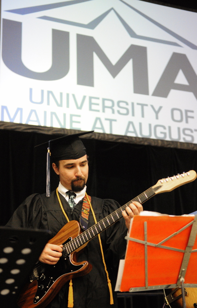 FRET-FREE DAY: Rurik Brackett plays guitar with the UMA Jazz on Tour band before the University of Maine at Augusta graduation ceremony Saturday at the Augusta Civic Center.
