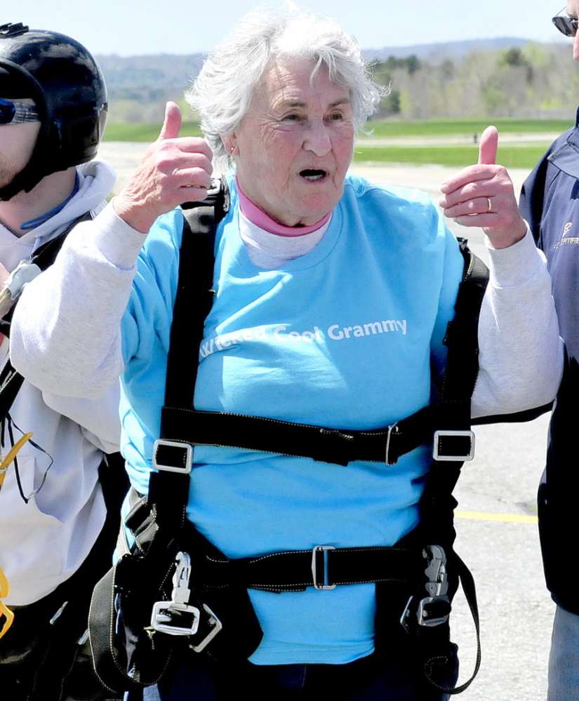 YOUNG AT HEART: Marjorie Bell, who turned 80 on Saturday, gives the thumbs-up sign to family members after she successfully skydived in tandem at LaFleur Airport in Waterville on Mother’s Day, Sunday, May 11, 2014.