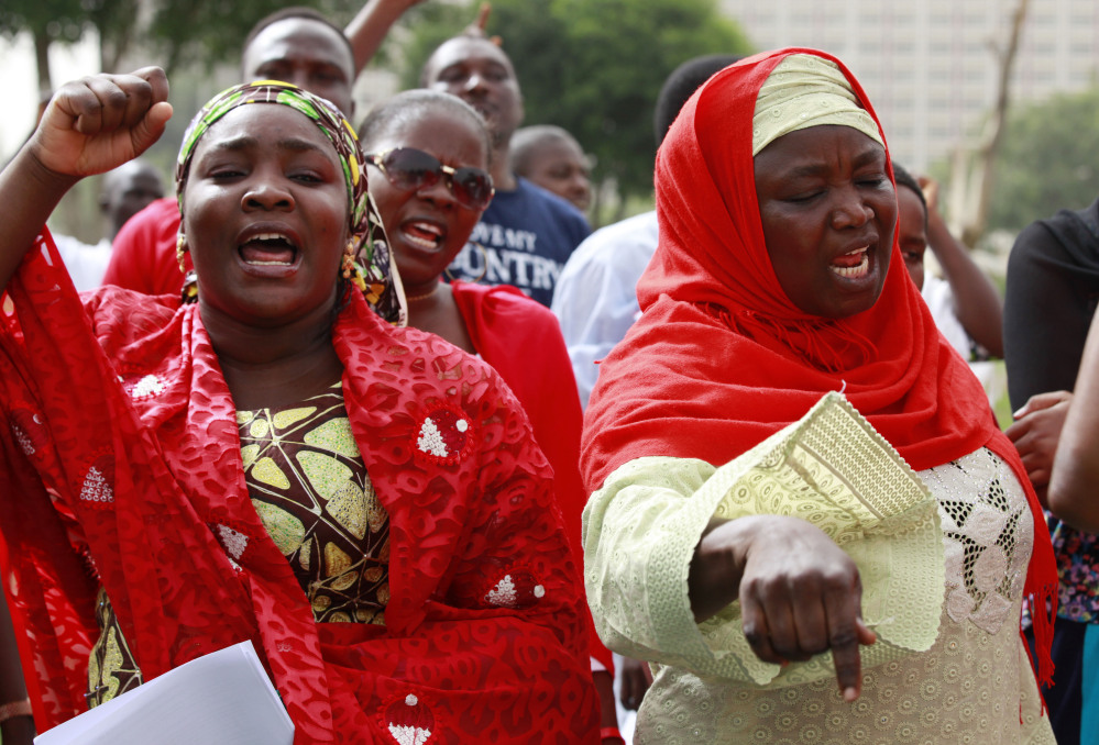 Women shout slogans during a rally Sunday calling on the Nigerian government to rescue the schoolgirls kidnapped from their school in Abuja, Nigeria. Secretary of State John Kerry said the United States offered aid "from day one" of the crisis.