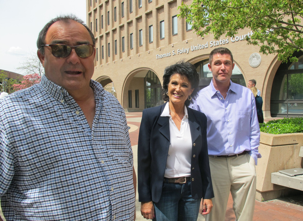 Larry Harvey, left, Rhonda Firestack-Harvey, and Rolland Gregg stand in the plaza in front of the federal courthouse in Spokane, Wash. The three are charged with growing marijuana at a remote farm near Kettle Falls, Wash., and each faces mandatory minimum sentences of at least 10 years in prison after they were caught growing about 70 pot plants on their rural, mountainous property.