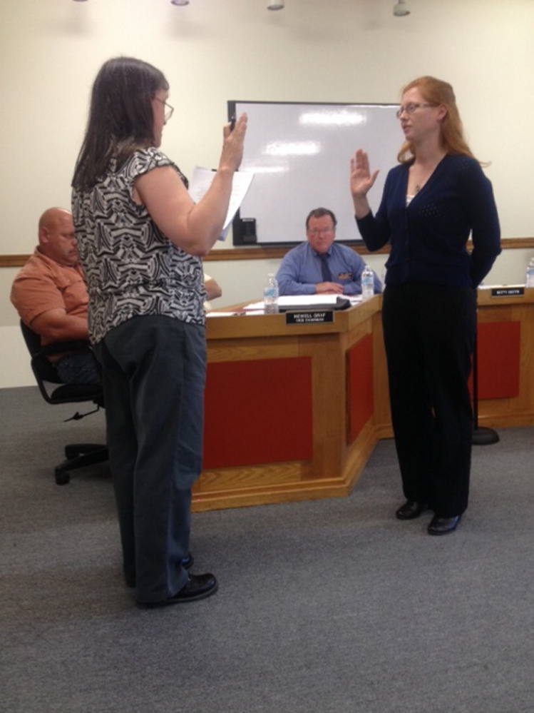 New boss: Skowhegan Town Clerk Gail Pelotte, left, administers the oath of office on Tuesday to new Town Manager Christine Almand as Skowhegan Road Commissioner Greg Dore, center, who served three months as interim town manager, watches.