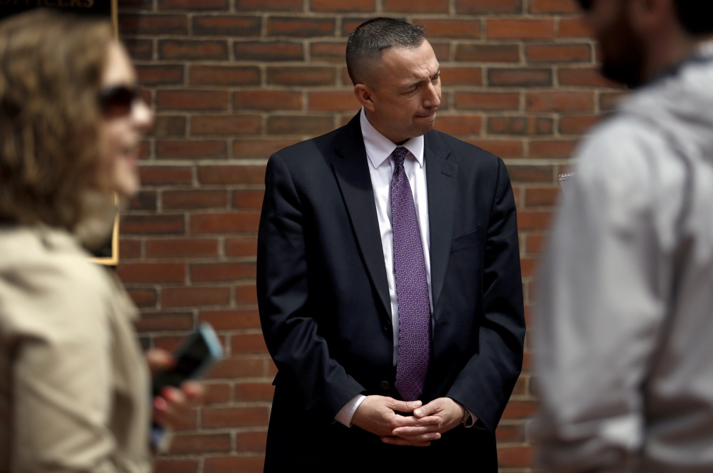 Portland Police Chief Michael Sauschuck talks with a reporter Tuesday after a news conference. Officials sought to reinforce residents’ sense of security after a report said three violent gangs operate in the city. “I take umbrage with the characterization. ... That is not the case in any way,” he said.