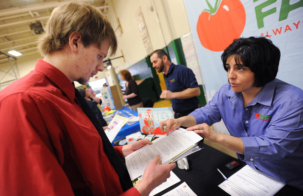 JOB SEEKING: United Technologies Fire and Safety employee John Faloon of Hartland talks with Backyard Farms director of human resources Dawn Palmer during the job fair in Pittsfield on Wednesday. Fallon will lose his job when UTC closes next spring.