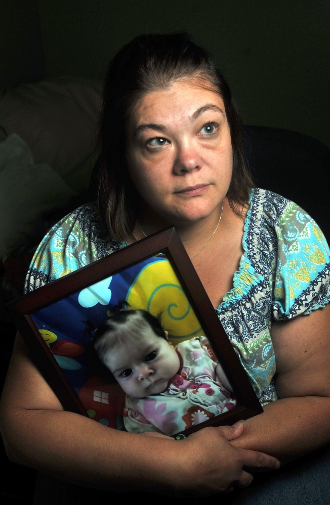 Nicole Greenaway holds a picture of her daughter Brooklyn Foss-Greenway at her home in Clinton. Her 3-month-old baby died while in the care of a friend July 8.