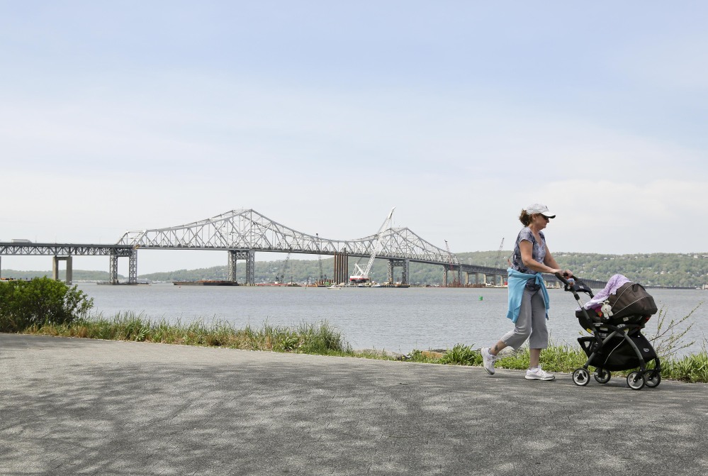 A woman takes a stroll with her child along the Westchester Riverwalk just north of the Tappan Zee Bridge, Tuesday.