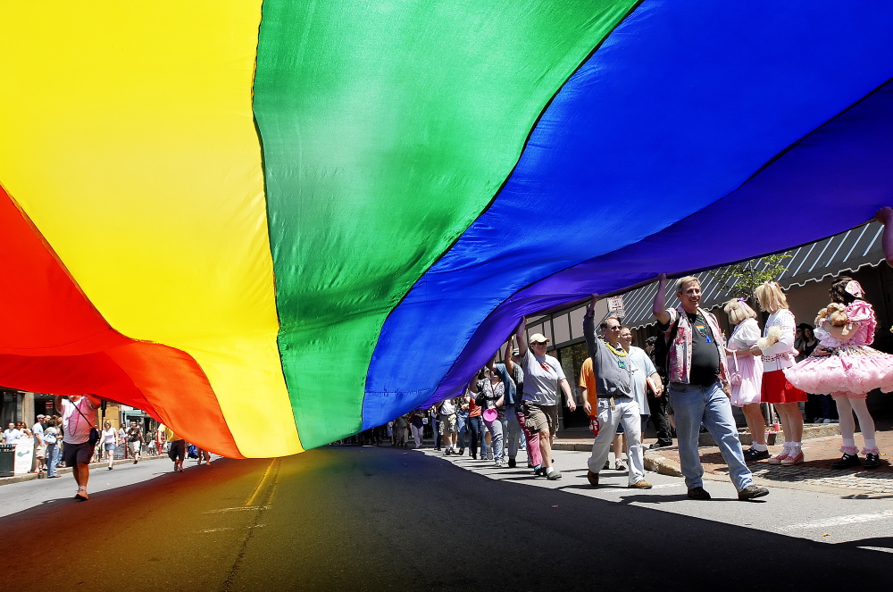 Participants in the gay pride parade six years ago march down Congress Street carrying an enormous rainbow flag, a symbol of the LGBT community.