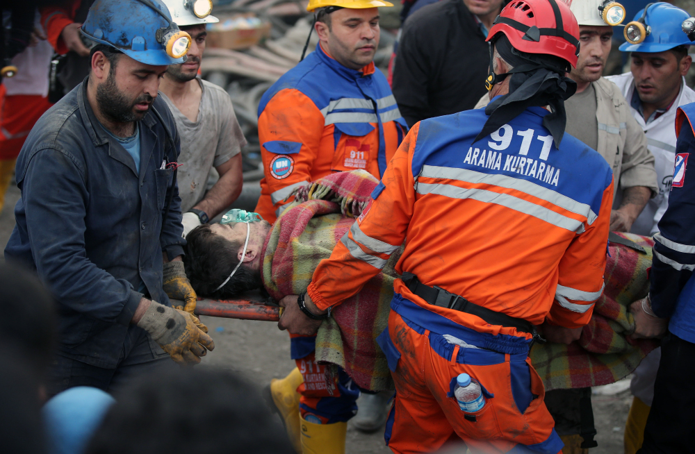 Rescue workers carry a miner rescued from the mine in Soma early Wednesday. Turkey’s energy minister said the fire was still burning inside the mine 18 hours after the blast.