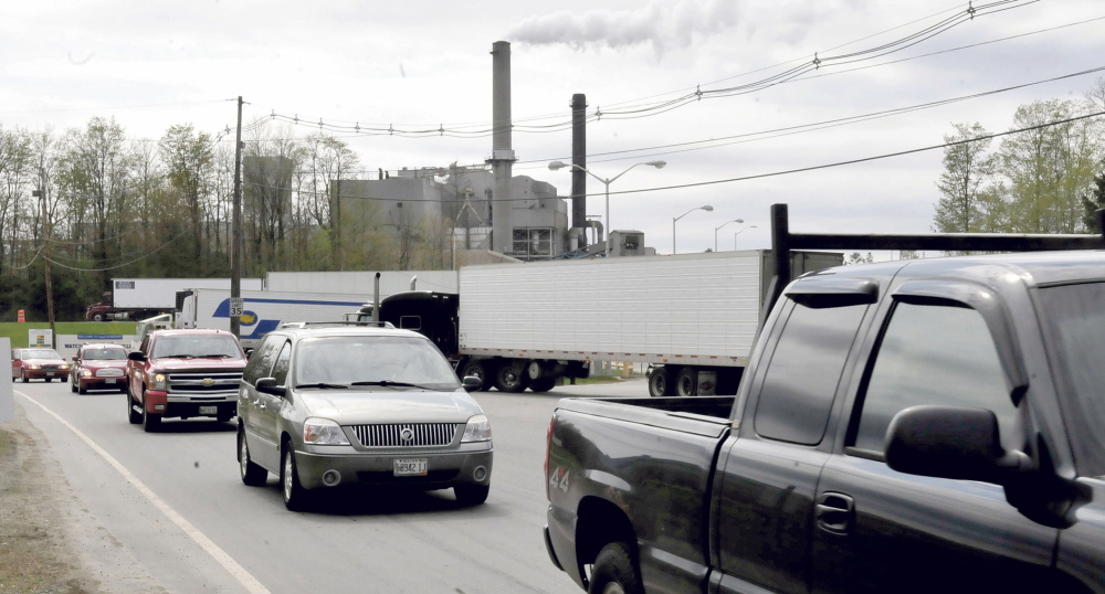 shift change: Workers at the Sappi paper mill in Skowhegan exit the mill on Wednesday. The parent company has announced a 5 percent reduction in its nationwide workforce, also affecting the Skowhegan operation.