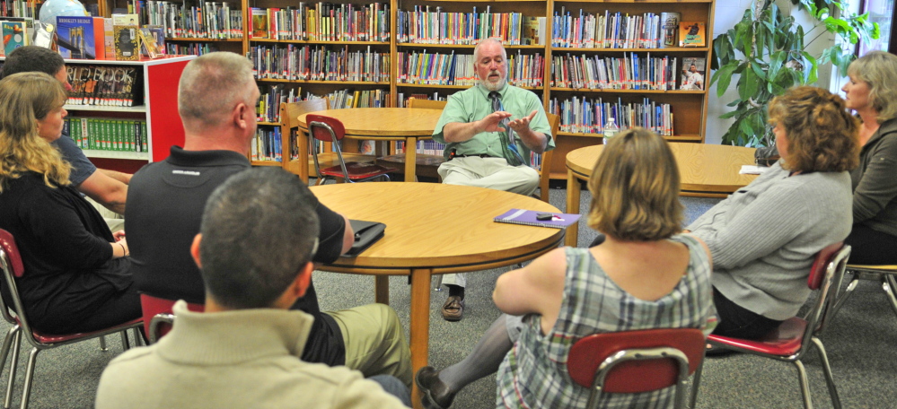 Staff photo by Joe Phelan SOMETHING TO REPORT: Richmond Middle and High School principal Steven Lavoie speaks to a small group of parents during a meeting Thursday in the Richmond Middle School library.
