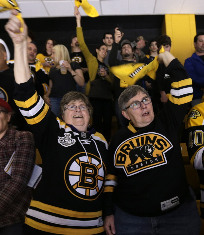 Marcia Hams, left, and Susan Shepherd cheer the Boston Bruins in Boston on Saturday. They were married on May 17, 2004.