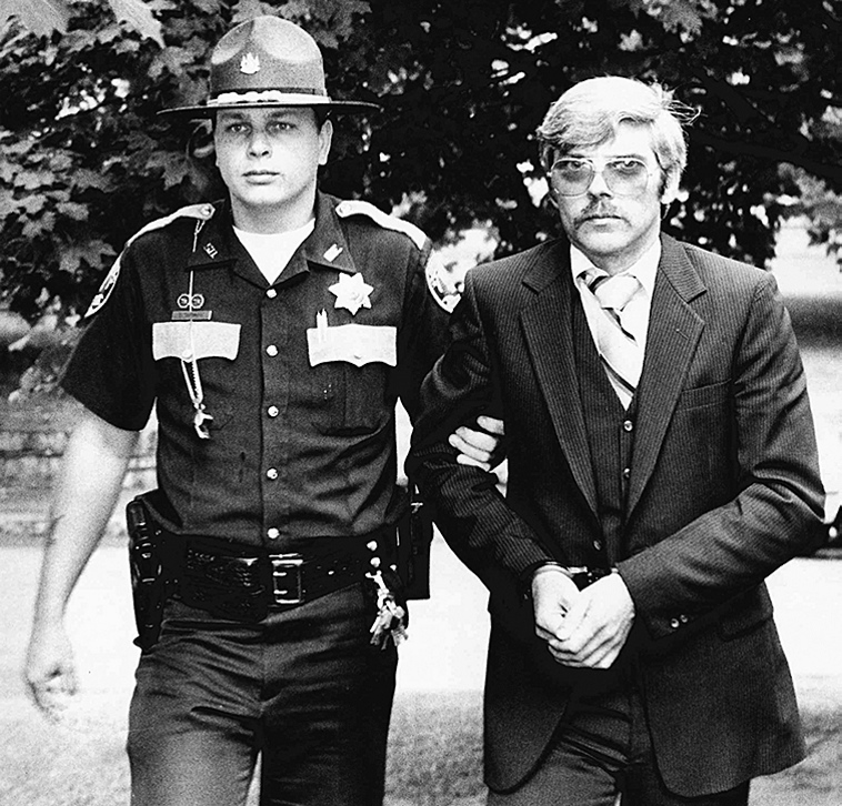 Caught: Michael Boucher, right, is escorted by Kennebec County Sheriff’s Deputy Eric Testerman in this July 9, 1991, file photo.