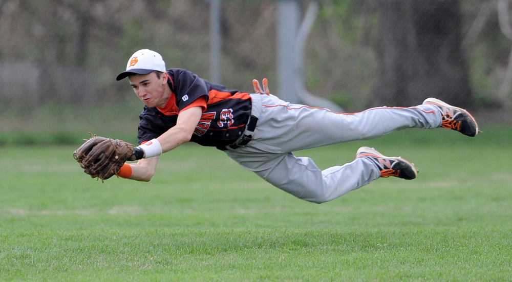 Staff photo by Michael G. Seamans Skowhegan Area High School's Chase Whittemore, 33, makes a diving catch to rob Mt. Blue High School of a hit in Farmington on Friday, May 16, 2014. Skowhegan defeated Mt. Blue 4-2.