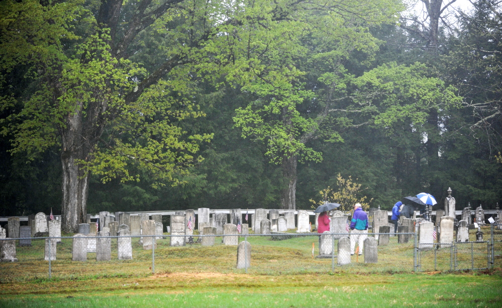 ‘An open-air museum’: Members of the Maine Old Cemetery Association walk through Frederic Cemetery in Starks on Saturday. Starks hosted the group’s annual spring meeting.