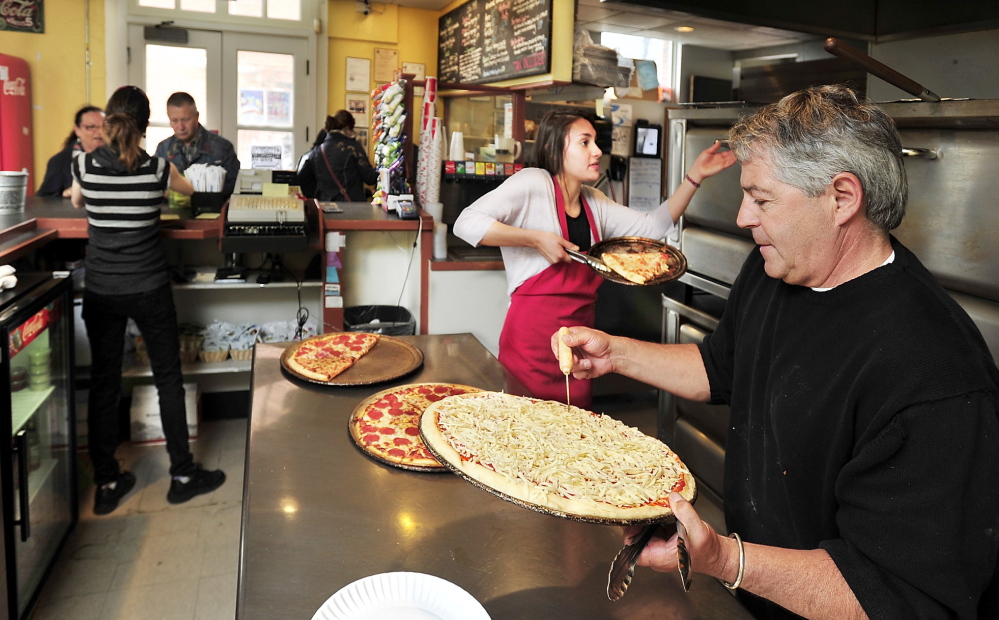 Owner John Bergeron helps employees at Bill’s Pizza, which received a 100-pie order from the Nova Star, above, this month.