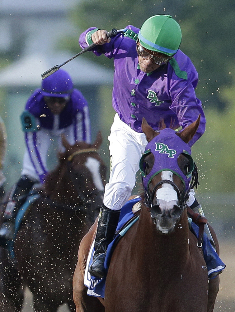 HOPING TO GO: Jockey Victor Espinoza celebrates aboard California Chrome after winning the 139th Preakness Stakes on Saturday at Pimlico Race Course in Baltimore. California Chrome might abandon his Triple Crown bid if New York officials do not allow the colt to wear a nasal strip in the Belmont Stakes.