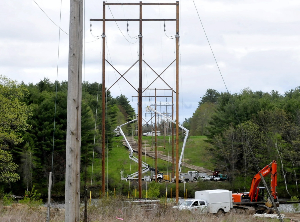 POWER UPGRADE: Utility employees work to upgrade Central Maine Power transmission lines in Skowhegan.