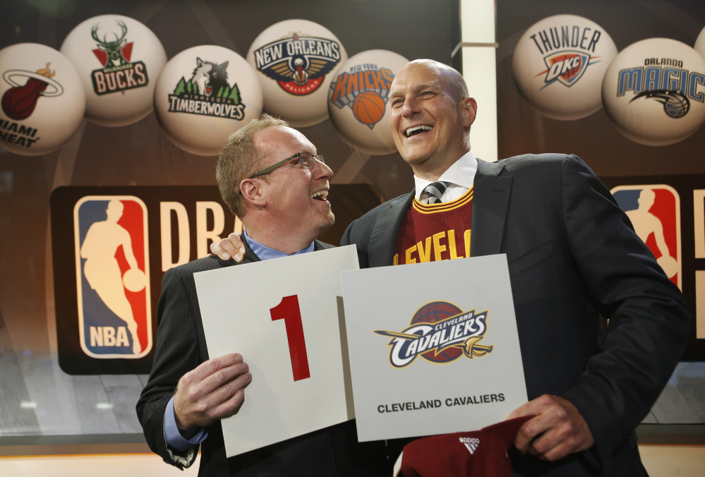 Cleveland Cavaliers general manager David Griffin, left, and minority owner Jeff Cohen celebrate after the Cavaliers won the top pick in the the NBA basketball draft lottery in New York, Tuesday, May 20, 2014. It’s the third time in four years the Cavs will be atop the draft after moving up from the ninth spot.