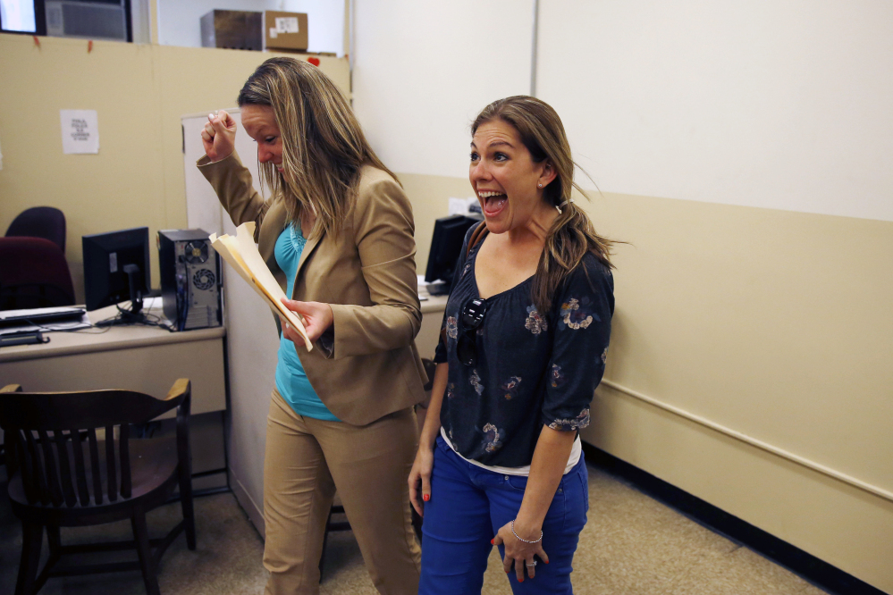 Ashley Wilson, left, and Lindsay Vandermay, right, both 29, react after getting their marriage license at the Philadelphia Marriage Bureau in City Hall, Tuesday, May 20, 2014, in Philadelphia. Pennsylvania’s ban on gay marriage was overturned by a federal judge Tuesday.