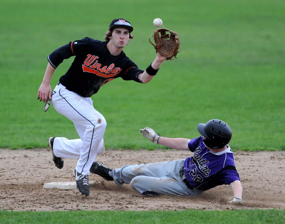 Staff photo by Michael G. Seamans Winslow High School’s Alex Berard, 17, is late getting the ball as Waterville Senior High School’sKaleb Kane, 22, slides in to second base on the steal attempt Tuesday.