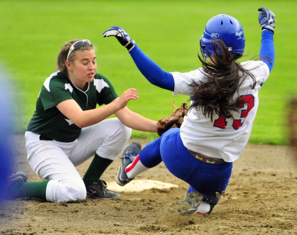 SAFE: Winthrop shortstop Lily Ouellette tries to tag out Oak Hill baserunner Jamie Prue Tuesday.