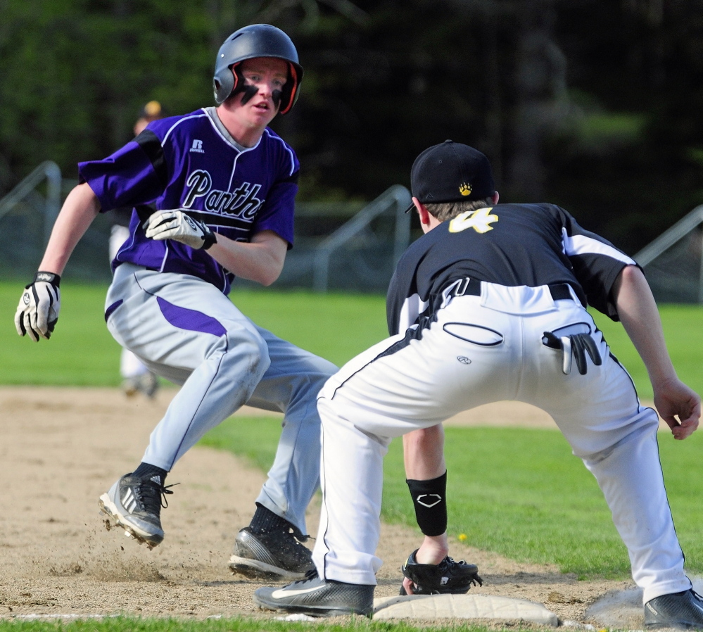AVOIDING THE TAG: Waterville baserunner Kaleb Kane, left, puts on the brakes and tries to reverse direction when he sees that Marancook third baseman Max McQuillen already has ball in his glove during a game Wednesday in Readfield.