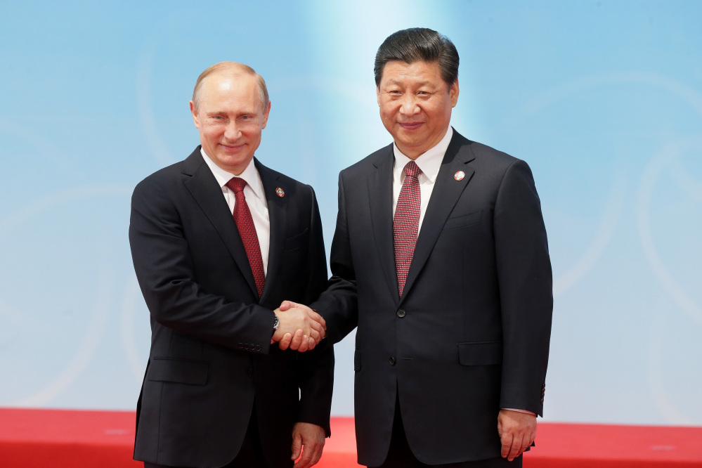 Russia’s President Vladimir Putin and China’s President Xi Jinping pose for a photo during the fourth Conference on Interaction and Confidence Building Measures in Asia, in Shanghai, China, on Wednesday.