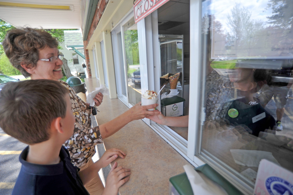 HOME-GROWN TREAT: Marge Veilleux and her grandson Nolan, 9, order ice cream at Gifford’s Ice Cream on Thursday afternoon on Silver Street in Waterville.