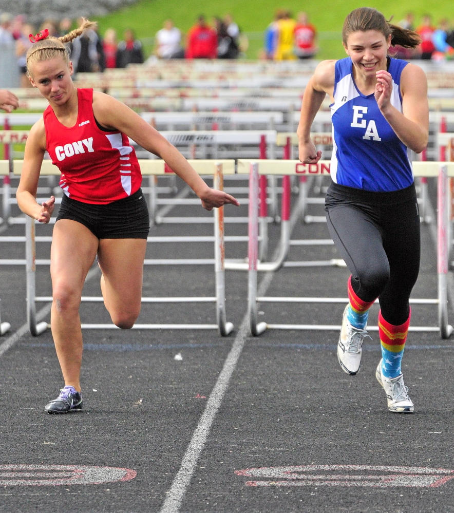 Staff photo by Joe Phelan FIGHT TO THE FINISH: Erskine Academy's Jade Canak, right, leads Cony's Madeline Reny to win the 100 meter hurdles during Capital City Classic.
