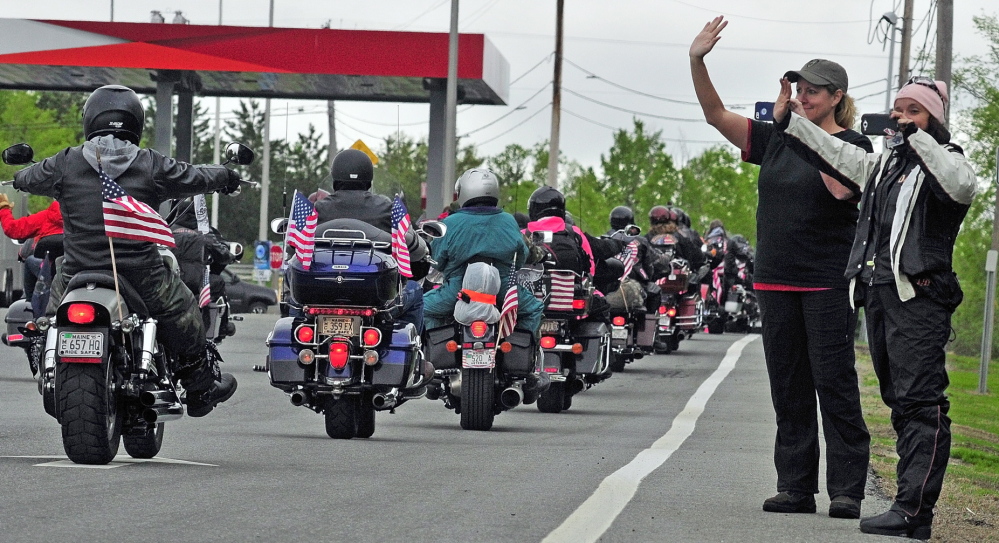 STONE POSSE: Michelle Moen, left, of Cape Elizabeth, and Brenda Smith, of Seabrook, N.H., wave as the Patriot Guard Riders pull away after a stopover by The Summit Project convoy on Friday at the West Gardiner rest area off the Maine Turnpike.