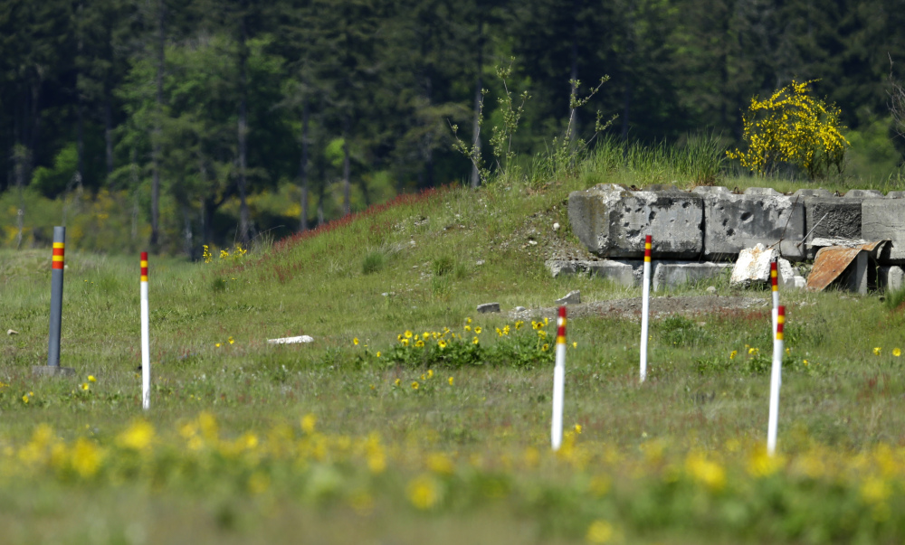 Markers near a bullet-pocked bunker designate a restricted area Joint Base Lewis McChord, Wash.