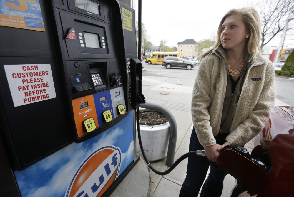 Katie Spillane of Brookline, Mass., fills her car with fuel at a gas station in Brookline. If the price of gasoline looks familiar this Memorial Day, that’s because it is.